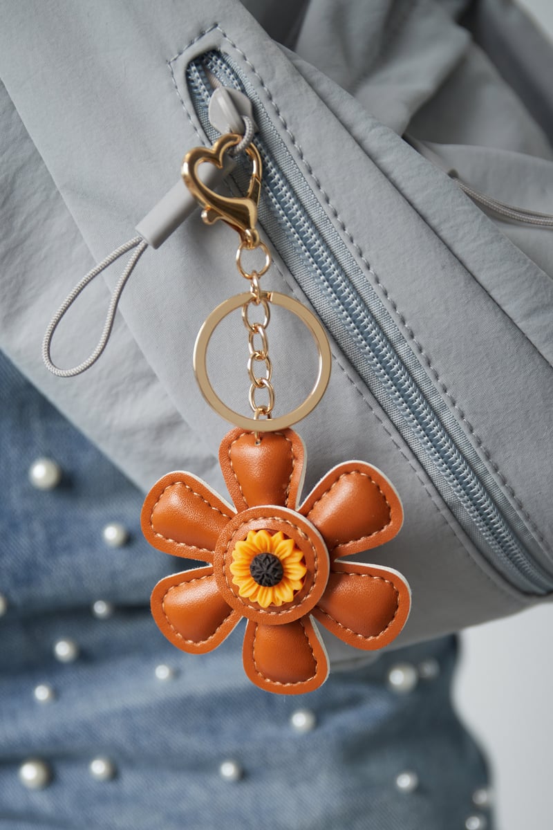 Floral charm, brown, hanging from a bag