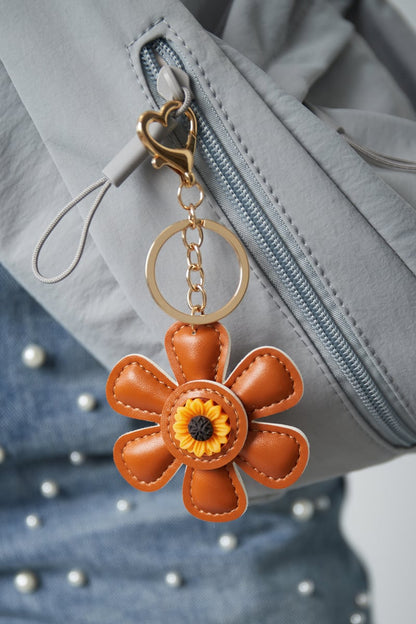 Floral charm, brown, hanging from a bag